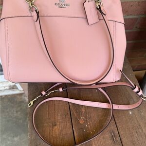 Coach Pink Shoulder Bag with Adjustable Strap and Zip Closure